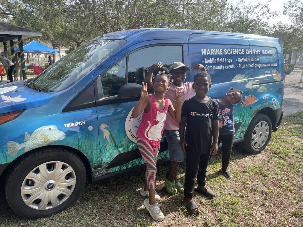 kids standing in front of the mobile education van